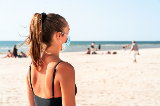 A woman wearing face mask at the beach