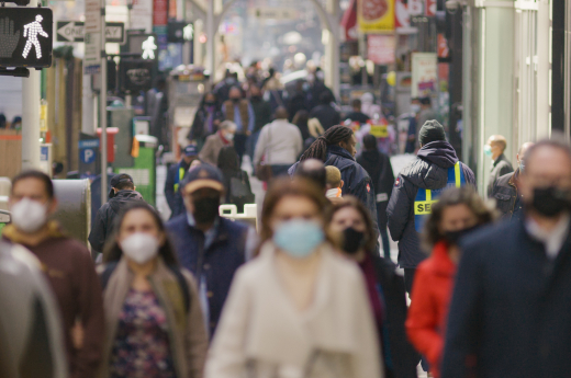anonymous-crowd-of-people-walking-wearing-masks-