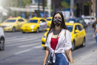 A Tourist Woman Wearing A Cloth Face Mask Walks On The Busy Streets Of Athens